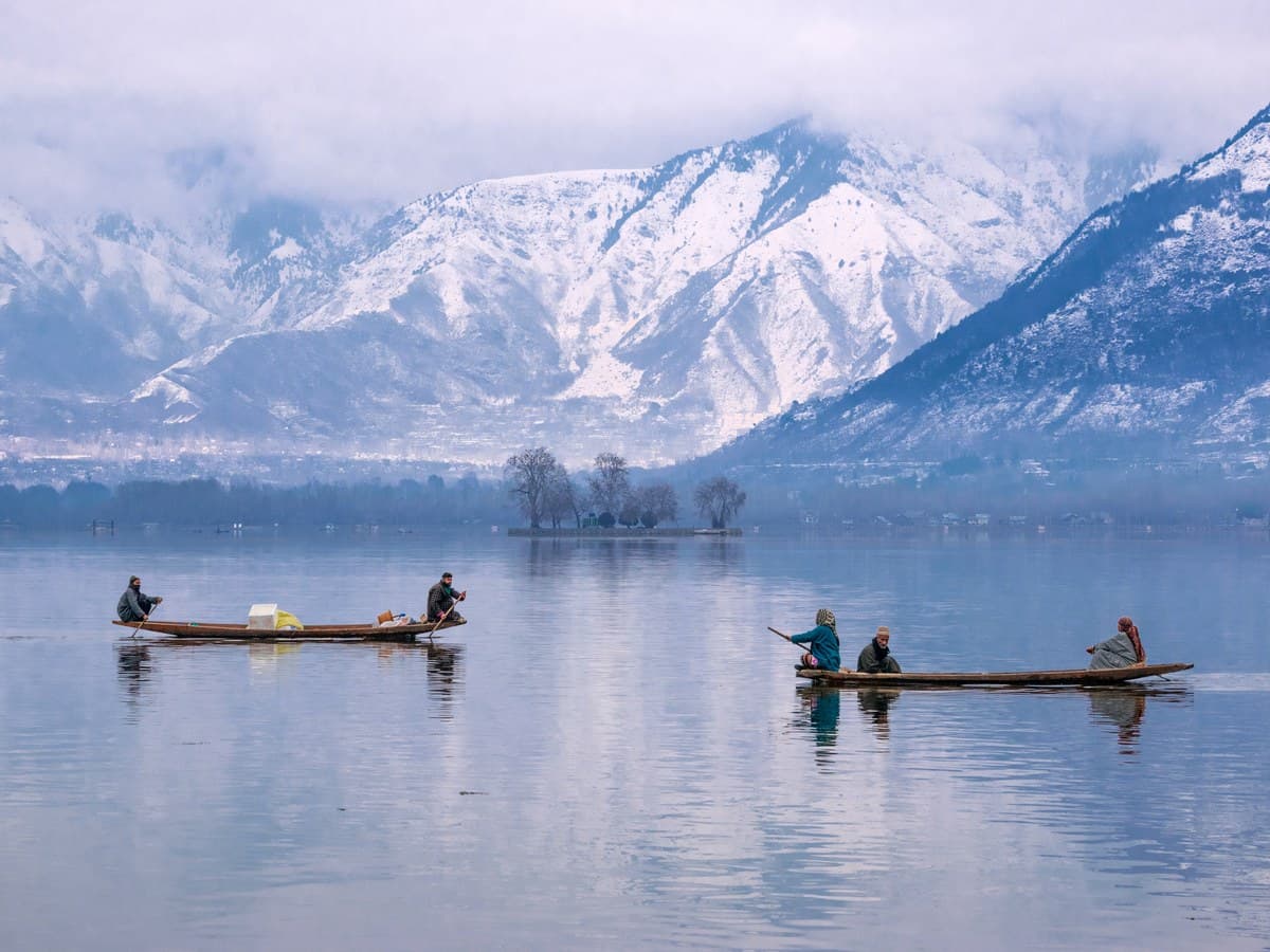 Kashmir Dal Lake shikara and snow mountains